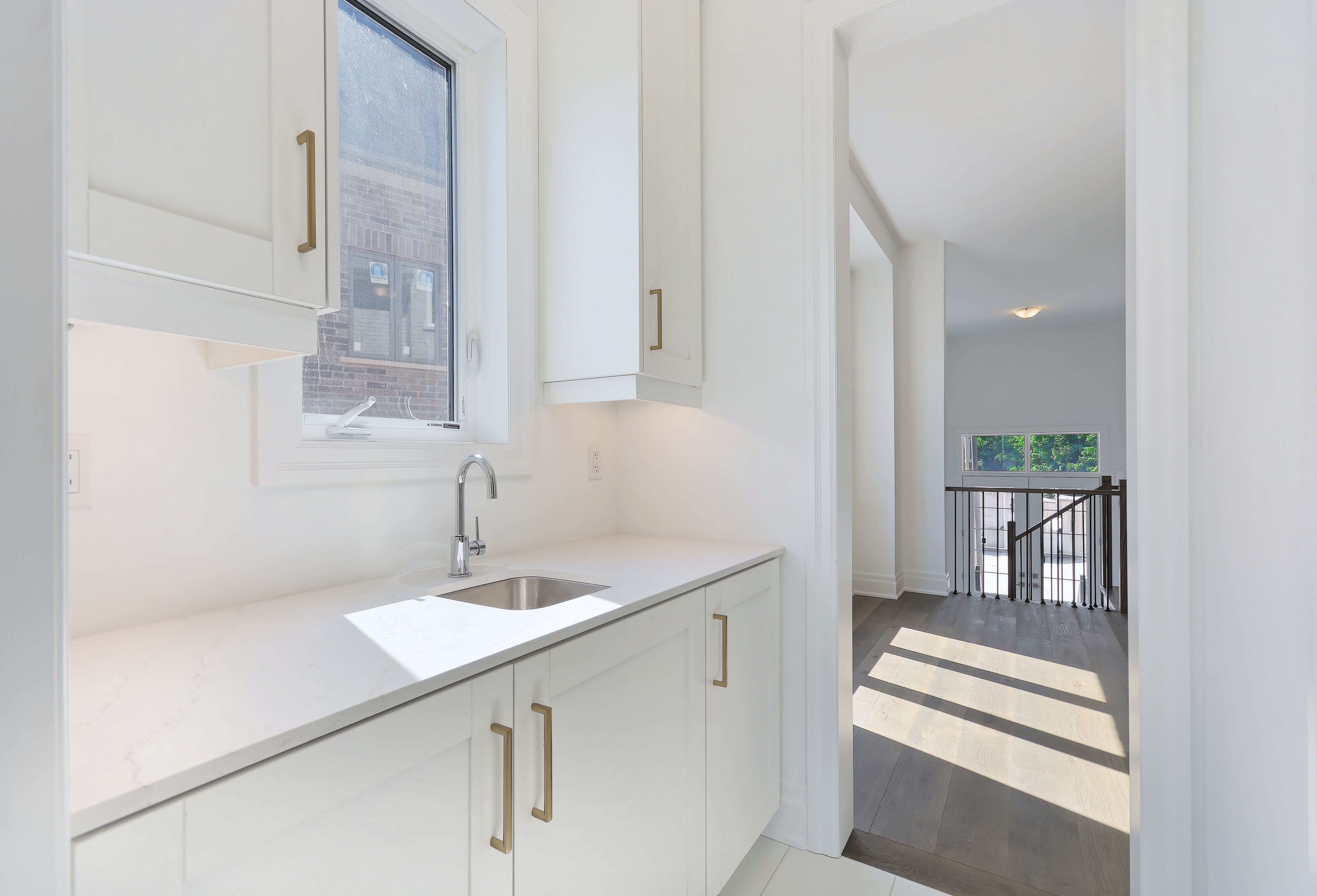 https://www.spectrumrealtyservices.com/images/019-The_Kitchen_Servery_Leads_to_the_Connecting_Dining_Room.jpg